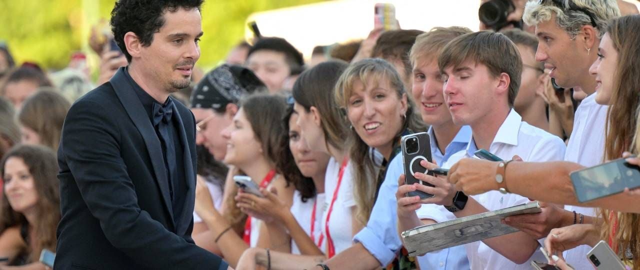 Damien Chazelle signs autographs at the Venice Film Festival
